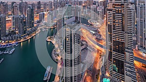 Dubai Marina skyscrapers and jumeirah lake towers view from the top aerial night to day timelapse in the United Arab