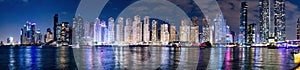 Dubai marina skyscrapers panorama in UAE at night.