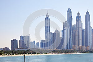 Dubai Marina skyscrapers with sea and beach in a sunny day, blue sky in Dubai