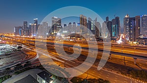 Dubai Marina skyscrapers and Sheikh Zayed road with metro railway aerial day to night timelapse, United Arab Emirates