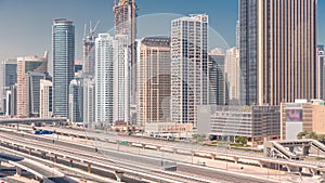 Dubai Marina skyscrapers and Sheikh Zayed road with metro railway aerial timelapse, United Arab Emirates