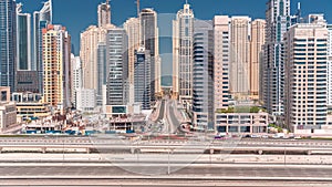 Dubai Marina skyscrapers and Sheikh Zayed road with metro railway aerial timelapse, United Arab Emirates