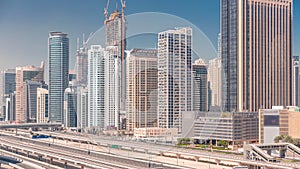 Dubai Marina skyscrapers and Sheikh Zayed road with metro railway aerial timelapse, United Arab Emirates