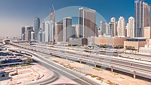 Dubai Marina skyscrapers and Sheikh Zayed road with metro railway aerial timelapse, United Arab Emirates