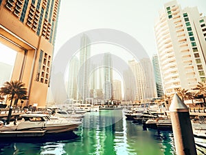 Dubai Marina with water pier and modern skyscrapers, United Arab Emirates