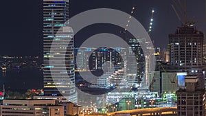 Dubai media city skyscrapers and construction site on palm jumeirah night timelapse, Dubai, United Arab Emirates