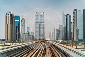 Dubai metro railroad at skyscrapers buildings skyline background