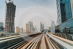 Dubai metro railroad at skyscrapers buildings skyline background