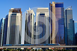 Dubai. Metro train moving on the background of skyscrapers