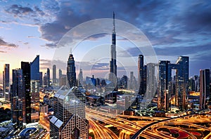 Dubai modern skyline architecture by night with illuminated skyscrapers, United Arab Emirates