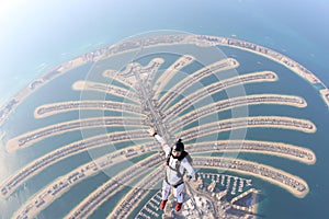 Dubai. Skydiving men in free fall above Dubai Palm