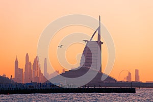 Dubai skyline beach at sunset. View of the hotels and Dubai marina skyscrapers in the background