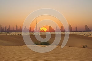 Dubai skyline or city silhouette at sunset seen from Arabian Desert