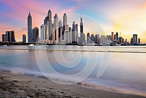 Dubai skyline Marina with reflecion at colorful sunset, UEA