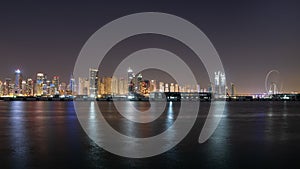 Dubai skyline at night with colorful reflections on the water