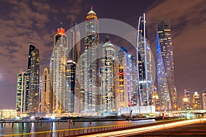 Dubai skyline at night with lights on the water and luxirious skyscrapers of UAE photo