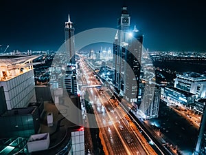 Dubai skyline at night, urban skyscrapers and car traffic, view from above, United Arab Emirates