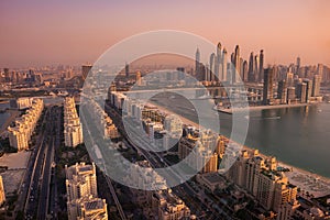 Dubai skyline on sunset, modern city with skyscrapers