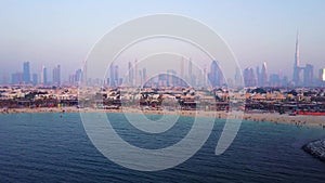 Dubai skyline view from coast or beach with city landscape and skyscrapers with Burj Khalifa background. Amazing aerial