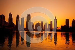 Dubai with skyscrapers against sunset in United Arab Emirates