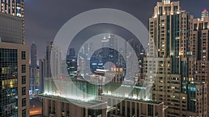 Dubai skyscrapers with illumination in business bay district night timelapse.