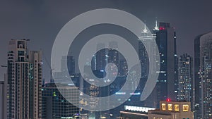 Dubai skyscrapers with illumination in business bay district night timelapse.