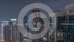 Dubai skyscrapers with illumination in business bay district night timelapse.