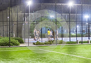 Dubai, UAE - 08.16.2022 - Youth on the basketball pitch at The pulse residence, Dubai South. Street