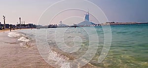 Dubai. UAE - 11.19.2022 - Jumeirah public beach in Dubai with famous seven star hotel Burj Al Arab on the background. Outdoors