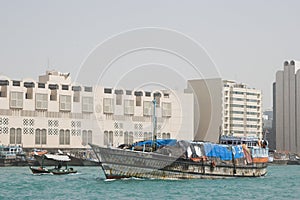 Dubai UAE A dhow an old wooden sailing vessel filled with cargo leaves the dock in Deira.