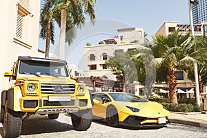 DUBAI, UAE - JANUARY 08, 2019: yellow luxury supercar Lamborghini Aventador Roadster and Gelandewagen in Dubai