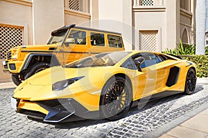 DUBAI, UAE - JANUARY 08, 2019: yellow luxury supercar Lamborghini Aventador Roadster and Gelandewagen in Dubai