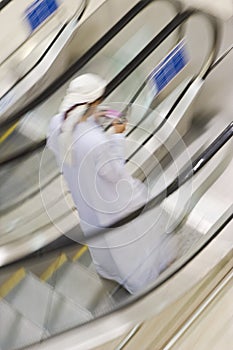 Dubai UAE A man traditionally dressed in a dishdash and gutra white robe and headdress. photo