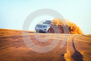 Off-road adventure with Nissan Patrol SUV in Arabian Desert at sunset. Offroad vehicle bashing through sand dunes