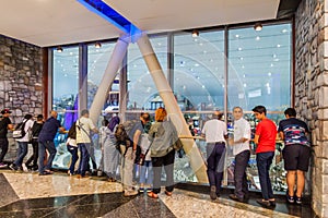 DUBAI, UAE - OCTOBER 21, 2016: People watch Ski Dubai, indoor ski resort in Mall of Emirates shopping mall in Dubai