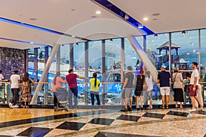 DUBAI, UAE - OCTOBER 21, 2016: People watch Ski Dubai, indoor ski resort in Mall of Emirates shopping mall in Dubai