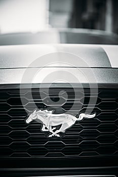 Dubai, UAE, United Arab Emirates - May 25, 2021: Close View Of Logo Logotype Sign Of Ford Mustang on grey hood. Ford