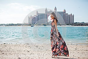 Dubai, United Arab Emirates. Pretty asian girl infront of Atlantis the Palm hotel from The Pointe waterfront dining and