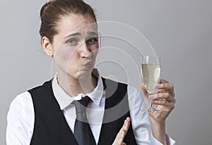 Dubious 20s girl resisting in drinking more Champagne at party