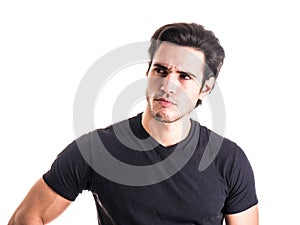 Dubious, unsure handsome young man on white