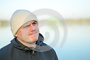 Dubious young man with a puzzled frown