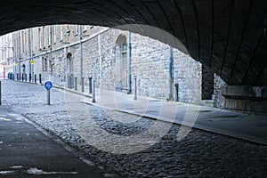 Railway bridge tunnel over cobblestone road