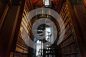 DUBLIN, IRELAND, DECEMBER 21, 2018: Magnificent spiral staircase in The Long Room in the Trinity College Library, home to The Book