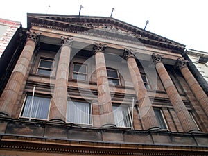 Dublin, Ireland - December 29th 2012 : Facade of a building in red color, with columns and white windows