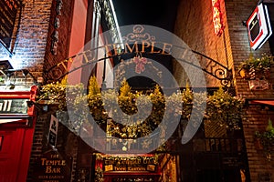 DUBLIN, IRELAND, DECEMBER 24, 2018: Temple Bar historic district, known as cultural quarter with lively nightlife. Nightscene of photo