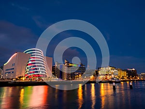 Dublin, Ireland -01.08.2023: Night shot of river Liffey and The Convention Centre Dublin illuminated with Irish flag color lights