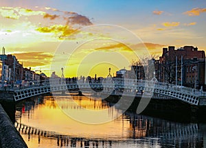 Dublin night scene with Ha`penny bridge and Liffey river lights