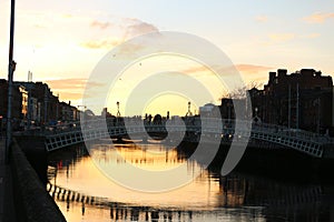 Dublin night scene with Ha`penny bridge and Liffey river lights . Ireland