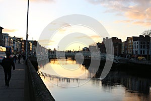 Dublin night scene with Ha`penny bridge and Liffey river lights . Ireland