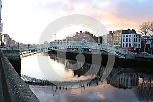 Dublin night scene with Ha`penny bridge and Liffey river lights . Ireland